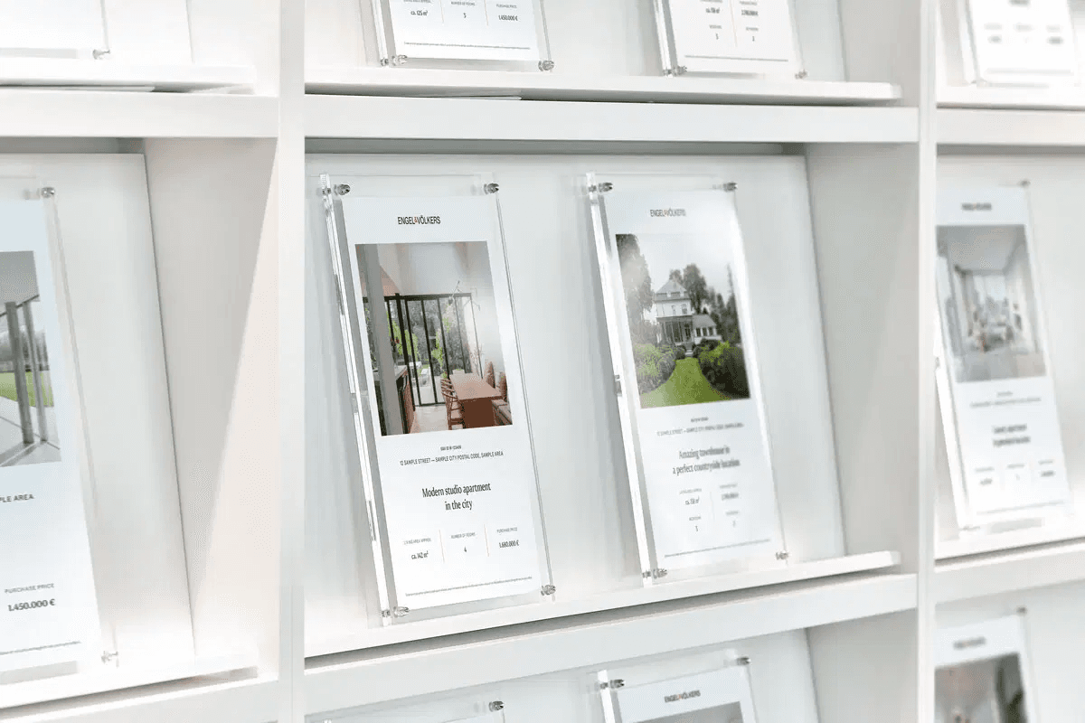A rack of printed Engel & Völkers property brochures