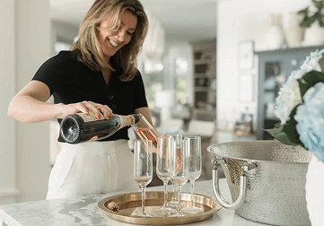 Meghan Laing pouring drinks in a bright Halifax home