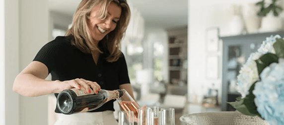 Meghan Laing pouring drinks in a bright Halifax home